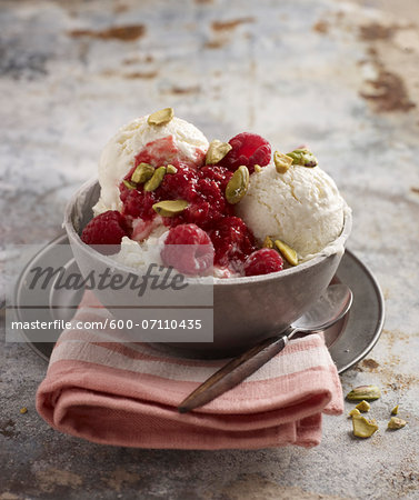 Bowl of Ice Cream with Raspberries and Pistachio Nuts, Studio Shot