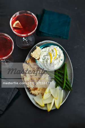 Overhead View of Cocktails and Pita Bread and Vegetables with Herb Dip, Studio Shot Overhead View of Cocktails and Pita Bread and Vegetables with Herb Dip, Studio Shot