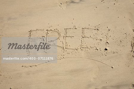 free word writing with small stones on sand beach ground