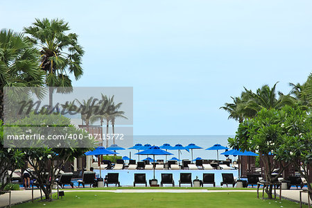 Deckchairs and swimming pool near the sea