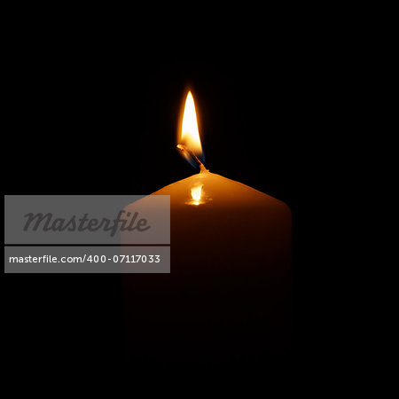 one burning candle, isolated on black background