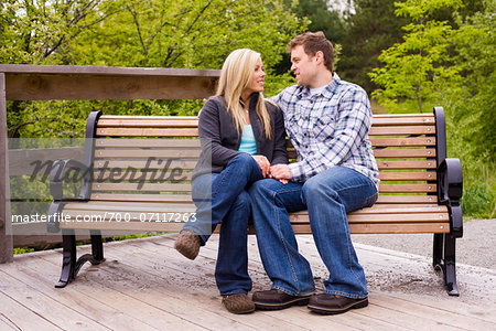 Young Couple on Park Bench, Scanlon Creek Conservation Area, Bradford, Ontario, Canada Young Couple on Park Bench, Scanlon Creek Conservation Area, Bradford, Ontario, Canada