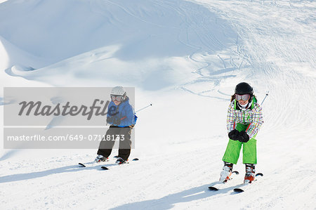 Brother and sister skiing, Les Arcs, Haute-Savoie, France