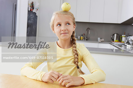 Girl with apple balanced on her head