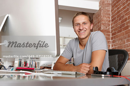 Portrait of young man at desk