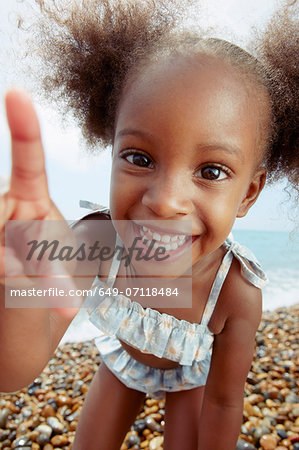 Child posing for camera at beach