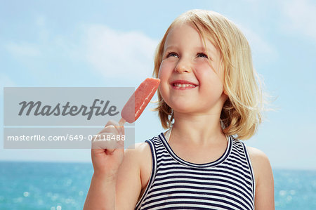 Child with ice lolly looking up Child with ice lolly looking up