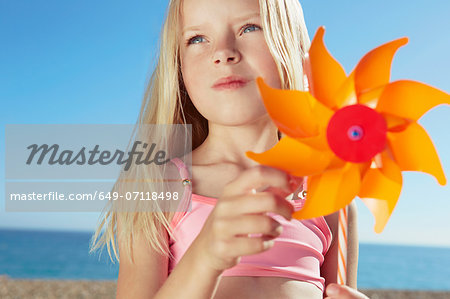 Girl holding toy windmill