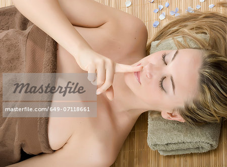 Woman at spa with finger on lips