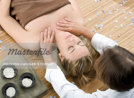 Woman at spa having shoulder massage