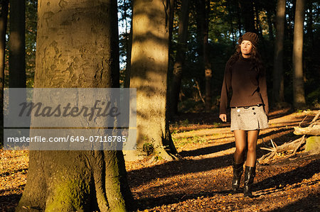 Portrait of young woman walking in forest