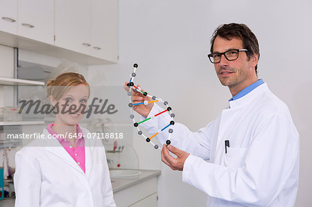 Portrait of two scientists with dna molecular model