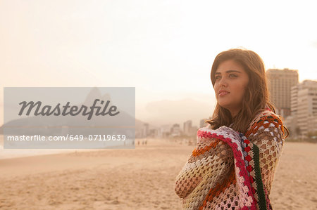Young woman wrapped in blanket, Ipanema Beach, Rio de Janeiro, Brazil Young woman wrapped in blanket, Ipanema Beach, Rio de Janeiro, Brazil