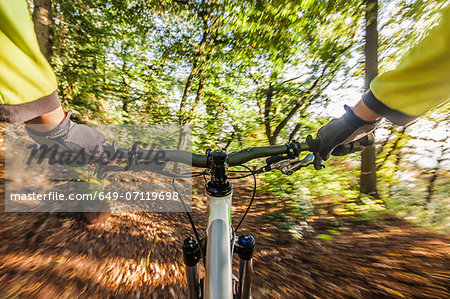 Man cycling through forest