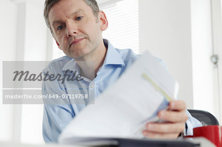 Mature businessman with paperwork