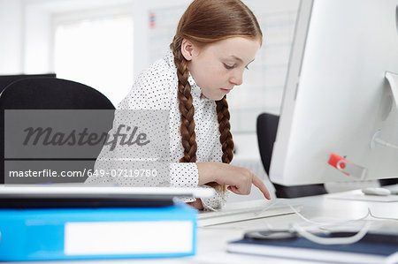 Girl using computer in office