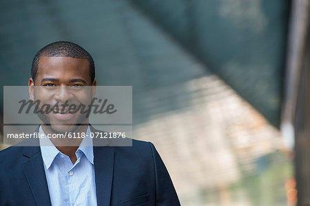 Summer. A Man In A Blue Jacket And Open Necked Shirt. Smiling.