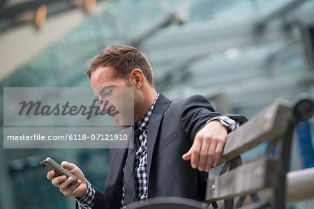 Business People. A Man In A Business Suit. A Man With Short Red Hair And A Beard, Wearing A Suit, On His Phone. Business People. A Man In A Business Suit. A Man With Short Red Hair And A Beard, Wearing A Suit, On His Phone.