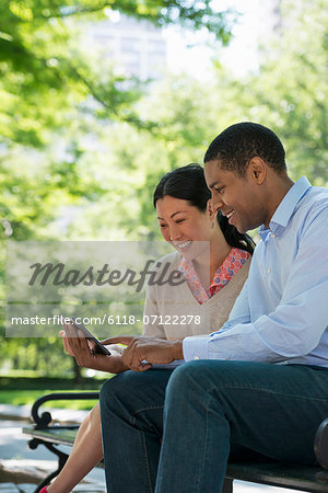 Summer. Business People. A Man And Woman Sitting Using A Digital Tablet, Keeping In Touch.