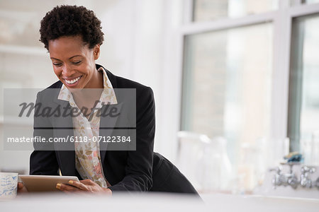 Business People. A Woman In A Black Jacket Using A Digital Tablet.