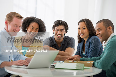 Business Meeting. A Group Sitting Down Around A Table.