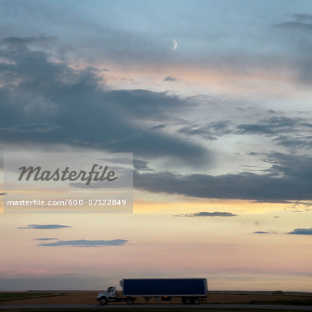 Transport truck at dusk on the Trans Canada Highway near Swift Current, Alberta, Canada