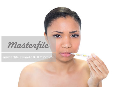 Sad young dark haired model using a thermometer on white background