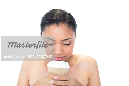Attractive young dark haired model enjoying coffee smell on white background