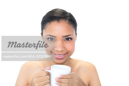 Content young dark haired model holding a mug of coffee on white background
