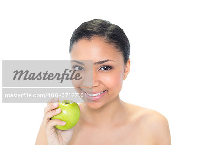 Beautiful young dark haired model holding a green apple on white background