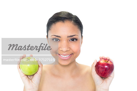 Happy young dark haired model holding apples on white background