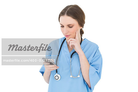 Pretty woman doctor using her smartphone while thinking