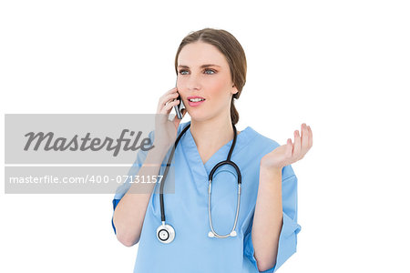 Young woman doctor phoning and making a certain gesture