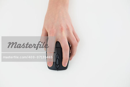 Close up of a hand using computer mouse on white surface