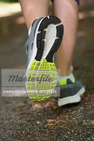 Woman running away from camera close up in trainers