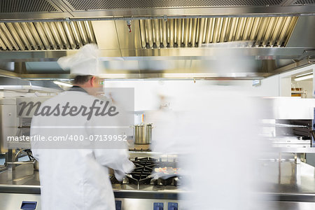 Chefs working in a kitchen at a hurried pace