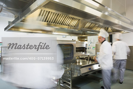 Team of chefs working in a kitchen at a hurried pace