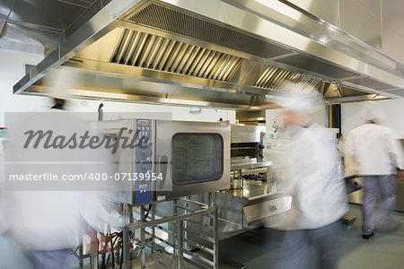 Team of chefs working in a commercial kitchen at a hurried pace