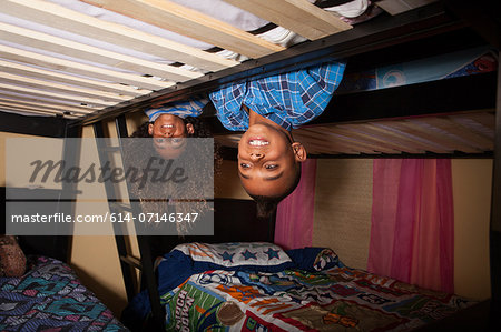 Two brothers leaning over bunkbed