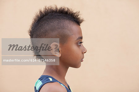 Portrait of boy with mohawk hairstyle, side view