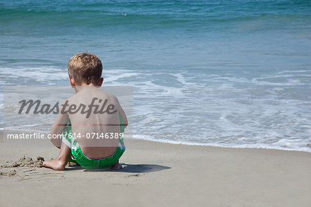 Male toddler playing on beach