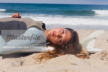 Young woman sunbathing, Hermosa Beach, California, USA