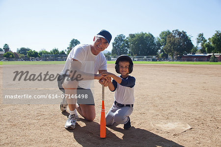 Man and grandson ready for baseball