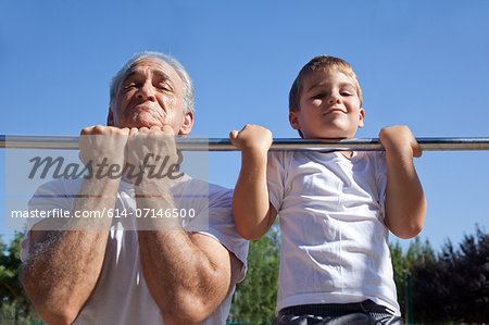 Man and grandson doing chin-ups