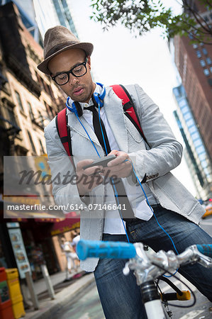 Young man on bike using smartphone