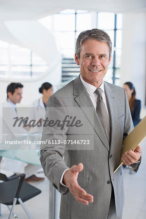 Businessman offering handshake in meeting