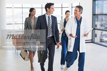 Doctors and business people talking in hospital