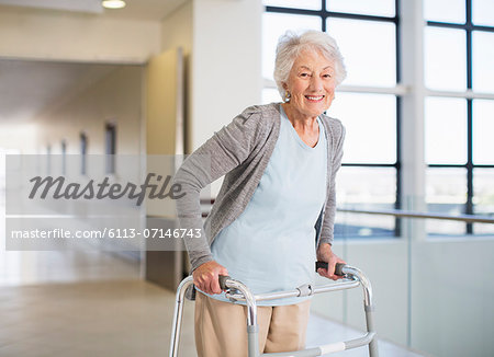 Senior patient using walker in hospital