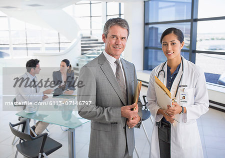 Portrait of smiling businessman and doctor in meeting