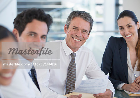 Portrait of smiling doctors and business people in meeting Portrait of smiling doctors and business people in meeting